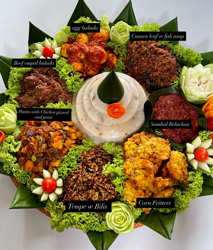 Tumpeng with white tasty rice, labelled: beef empal balado, egg balado, cassava leaf with smoked fish, potato with chicken gizzard and petai, tempe with bilis, corn fritters, sambal belacan